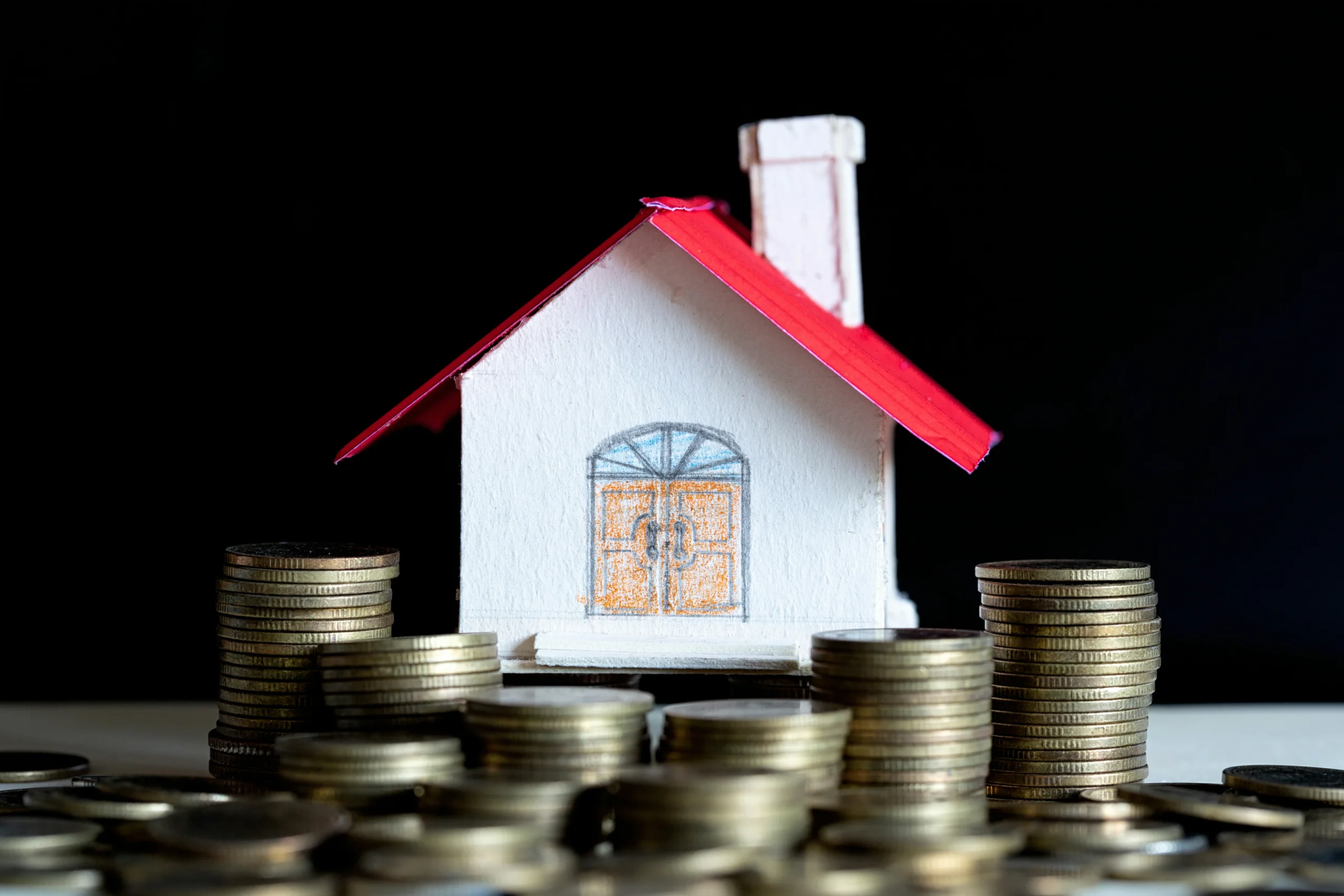 model-house-with-coins-wooden-table